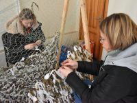 Weaving of camouflage nets for the Armed Forces by employees of the Scientific Library of the National Academy of Sciences.